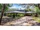 Stunning exterior view of a home with a covered carport and lush landscaping at 5655 Oak Hollow Ln, Oviedo, FL 32765