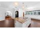 Spacious kitchen featuring an island with cooktop and views into the dining area at 5655 Oak Hollow Ln, Oviedo, FL 32765