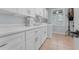 Clean laundry room featuring white cabinets, a sink, and modern appliances at 5655 Oak Hollow Ln, Oviedo, FL 32765