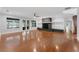 Spacious living room with hardwood floors, a stone fireplace, and natural light at 5655 Oak Hollow Ln, Oviedo, FL 32765