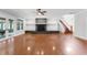 Bright living room featuring hardwood flooring, fireplace, and staircase at 5655 Oak Hollow Ln, Oviedo, FL 32765