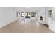 Spacious living room with white shiplap walls, tile floors, and a brick fireplace at 5655 Oak Hollow Ln, Oviedo, FL 32765