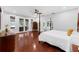 Spacious main bedroom with wood floors, a four poster bed, and a private terrace at 5655 Oak Hollow Ln, Oviedo, FL 32765