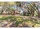 Landscaped backyard featuring a wooden playground and a petite cottage at 5655 Oak Hollow Ln, Oviedo, FL 32765