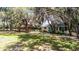 Lush outdoor area features a wooden playground set and an auxiliary cottage at 5655 Oak Hollow Ln, Oviedo, FL 32765