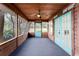 Charming screened porch with wood paneled ceiling and a view of the landscaped yard at 5655 Oak Hollow Ln, Oviedo, FL 32765