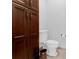 Powder room featuring a toilet and cabinet at 5655 Oak Hollow Ln, Oviedo, FL 32765