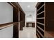 Spacious walk-in closet with custom shelves, drawers, hanging rods, and makeup vanity at 5655 Oak Hollow Ln, Oviedo, FL 32765