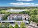 Scenic aerial view of a condominium complex with a lake and lush greenery at 581 Brantley Terrace Way # 302, Altamonte Springs, FL 32714