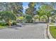 Secured gated entrance to a well-maintained neighborhood with paved brick roads and lush landscaping at 581 Brantley Terrace Way # 302, Altamonte Springs, FL 32714