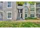 Building exterior featuring well-maintained landscaping, stairs, and neutral stucco at 581 Brantley Terrace Way # 302, Altamonte Springs, FL 32714