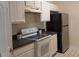 Kitchen featuring white cabinets, countertops, and stainless steel refrigerator at 581 Brantley Terrace Way # 302, Altamonte Springs, FL 32714