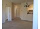 Inviting living space with neutral decor leads to a kitchen and bedroom hallway at 581 Brantley Terrace Way # 302, Altamonte Springs, FL 32714