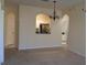 Open-concept living room showcasing arched doorways to the kitchen and bathroom at 581 Brantley Terrace Way # 302, Altamonte Springs, FL 32714