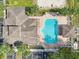 Aerial view of community pool, surrounded by lounge chairs, palm trees, and a cabana at 581 Brantley Terrace Way # 302, Altamonte Springs, FL 32714