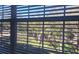 Bright, exterior view through blinds showcasing lush greenery and blue sky at 581 Brantley Terrace Way # 302, Altamonte Springs, FL 32714
