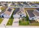 Aerial view of a single Gathering home with solar panels in a residential neighborhood at 6984 Dilly Lake Ave, Groveland, FL 34736