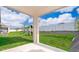 Covered patio view of the backyard with green lawn and a playset at 6984 Dilly Lake Ave, Groveland, FL 34736