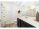 Well-lit bathroom featuring a black vanity, white countertop, and playful dinosaur-themed shower curtain at 6984 Dilly Lake Ave, Groveland, FL 34736