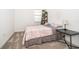 Comfortable bedroom with floral bedding, a leaning shelf with greenery, and a side table with a lamp at 6984 Dilly Lake Ave, Groveland, FL 34736