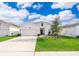 Charming single-Gathering home with a well-manicured lawn and attached two-car garage at 6984 Dilly Lake Ave, Groveland, FL 34736
