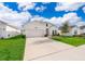 Inviting one-story home with a spacious driveway and lovely landscaping at 6984 Dilly Lake Ave, Groveland, FL 34736