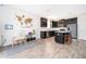 Open view of the kitchen with dark cabinetry, light countertops, and an adjacent playroom at 6984 Dilly Lake Ave, Groveland, FL 34736