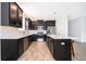 Modern kitchen featuring black cabinets, stainless steel appliances, and a white subway tile backsplash at 6984 Dilly Lake Ave, Groveland, FL 34736