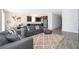 Spacious living room with a large rug, comfortable gray sofas, and an open layout with a world map wall decal at 6984 Dilly Lake Ave, Groveland, FL 34736