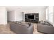 Comfortable living room with neutral tones, stylish furnishings, a patterned rug, and a large built-in entertainment center at 6984 Dilly Lake Ave, Groveland, FL 34736