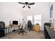Bright office space with dual workstations, carpeted floors, and a modern ceiling fan at 6984 Dilly Lake Ave, Groveland, FL 34736