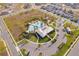 Aerial view of a beautiful community pool, clubhouse, and parking area at 6984 Dilly Lake Ave, Groveland, FL 34736