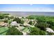 Scenic aerial view of neighborhood near lake, showcasing lush trees and charming homes at 701 Lakeshore Blvd, St Cloud, FL 34769