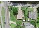 Bird's-eye view of a home featuring a lush backyard and tree-lined street at 701 Lakeshore Blvd, St Cloud, FL 34769