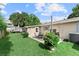 Charming backyard with a patio, dining set, string lights, and well-maintained lawn at 701 Lakeshore Blvd, St Cloud, FL 34769