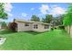 Lush backyard with well-maintained lawn, privacy fence, and attractive landscaping at 701 Lakeshore Blvd, St Cloud, FL 34769