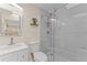 Modern bathroom boasts a glass-enclosed shower, sleek vanity, and contemporary fixtures at 701 Lakeshore Blvd, St Cloud, FL 34769