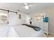 Comfortable bedroom features a ceiling fan, barn door closet, and stylish decor at 701 Lakeshore Blvd, St Cloud, FL 34769