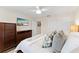Bedroom with warm tones features a mounted TV, closet, and comfortable furnishings at 701 Lakeshore Blvd, St Cloud, FL 34769