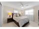 Well-lit bedroom with ceiling fan, plush bedding, and a soothing ambiance at 701 Lakeshore Blvd, St Cloud, FL 34769