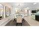 Contemporary dining room features a glass table, modern chandelier, unique plate wall decor, and lots of natural light at 701 Lakeshore Blvd, St Cloud, FL 34769