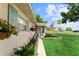 Quaint single-story home featuring lush landscaping, an American flag, and a screened porch at 701 Lakeshore Blvd, St Cloud, FL 34769