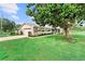 Well-maintained single-story home featuring an attached garage and mature landscaping at 701 Lakeshore Blvd, St Cloud, FL 34769