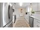 Updated kitchen boasts stainless steel appliances, white cabinetry, and modern fixtures, offering a clean and stylish cooking space at 701 Lakeshore Blvd, St Cloud, FL 34769