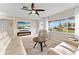 Inviting living room featuring a modern fireplace, ceiling fan, and large window offering pleasant outdoor views at 701 Lakeshore Blvd, St Cloud, FL 34769