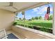Inviting screened porch view with a fan and American flag, offering a glimpse of the front yard at 701 Lakeshore Blvd, St Cloud, FL 34769