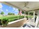 Relaxing screened porch with white rocking chairs, overlooking a verdant lawn and neighborhood at 701 Lakeshore Blvd, St Cloud, FL 34769