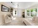Bright sunroom with neutral tones, featuring comfortable seating, plants, and ample natural light through large windows at 701 Lakeshore Blvd, St Cloud, FL 34769