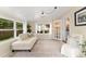 Cozy sunroom with large windows, comfortable seating, and access to the outdoors through French doors, creating a relaxing retreat at 701 Lakeshore Blvd, St Cloud, FL 34769