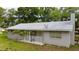 An exterior side view of a single-story home with a chimney and small porch at 715 Ballard St, Altamonte Springs, FL 32701